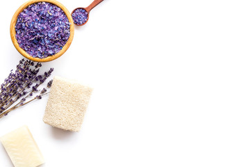 Spa set with lavender spa salt. Purple spa salt near dry lavender branches and washcloth on white background top view copy space
