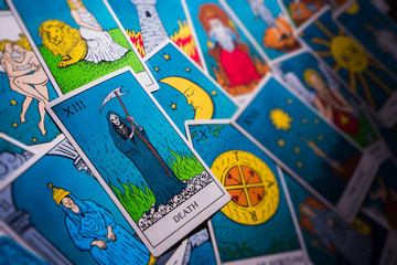 Tarot cards distributed randomly on top of each other