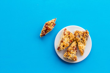 Homemade cookies made of shortcake dough and jam on blue background top view space for text