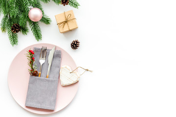 Christmas table setting with gift box and fir tree white background top view mockup