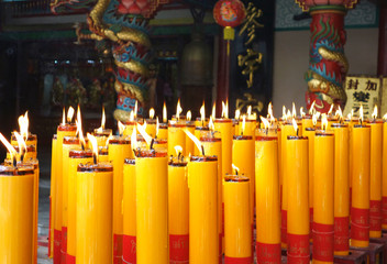 Many Big burnimg Candles in chinese temple