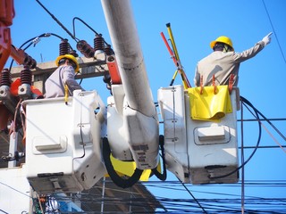 Electricians are repairing high-voltage electricity on high, to repair defective equipment, which...
