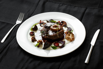 Close up of meat dish with grilled vegetables