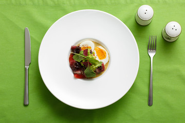 Top view of dish eggs with meet and salad on plate