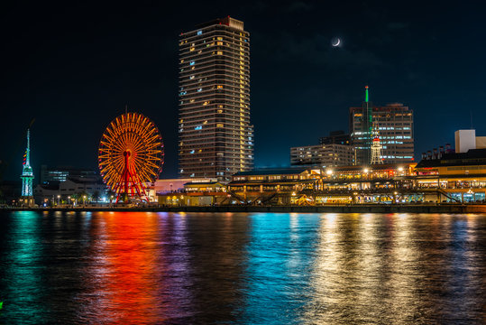 beautiful night view of Kobe port with lights and reflection in water, Japan