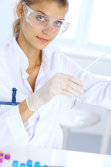 Female scientific researcher or blood test assistant at work in laboratory. Science, medicine and pharmacy concept