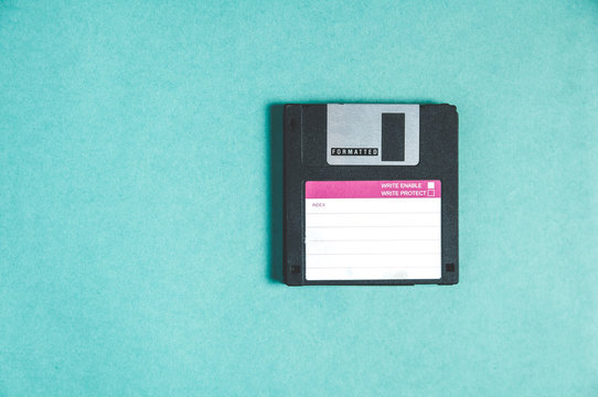Old floppy disks for computer on green background