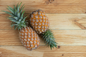 Ripe pineapple isolated on a wooden table