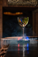Transparent Alcoholic cocktail with mint on the bar counter