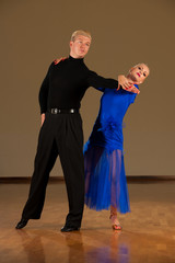 latino dance couple in action  preforming a exhibition dance - wild samba