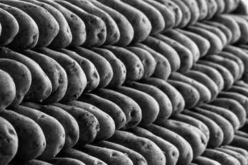 Stacked Potatoes On The Counter In The Market Stock Photo
