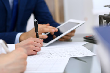 Bookkeepers team or financial inspectors  making report, calculating and checking balance. Tax service financial document. Audit or meeting concept