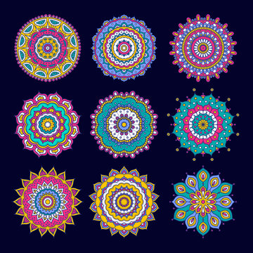 Set of colorful doodle mandalas. Circle lace ornament. Vector hand drawn ethnic floral pattern. Abstract tribal flowers set. Bright elements on dark blue background.