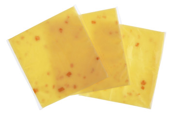 Plates of melted cheese with pieces of bacon in square plastic bags isolated
