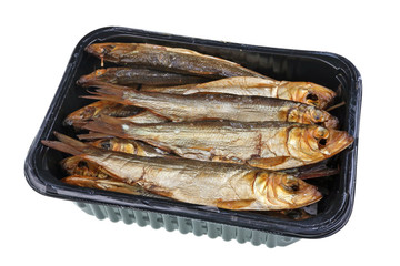 Hot  whole  smoked  capelin saury sprat  Baltic sea  fish with heads and guts in plastic box -  traditional Lithuanian beer snack isolated