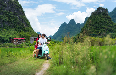 Couple riding motorbike around rice fields of Yangshuo, China