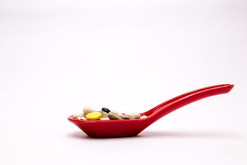 Colorful capsules with spoon. multivitamin, omega , Medical pills