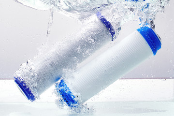 New carbon filter cartridge for house water filtration system isolated on white background. Splash. Concept.