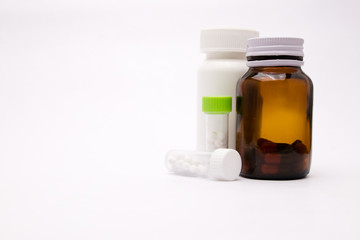 White and brown bottle of medicine Bottles and small homeopathic remedies