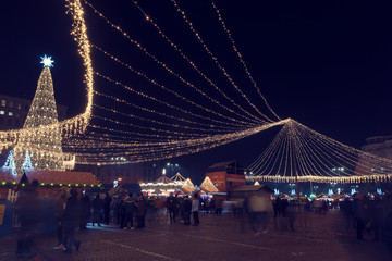 13 DEC 2018, Romania, Bucharest. Christmas tree and rich decoration lights at Christmas market in Bucharest. Long exposure image. Selective focus