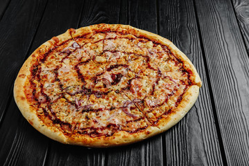 pizza barbecue sauce with chicken on black wooden background top view