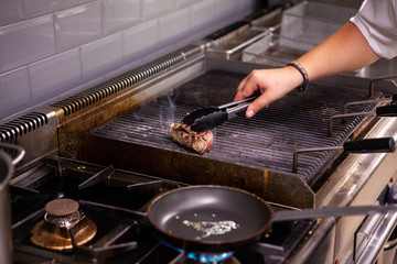 Chef making beef on restaurant grill. Making great food