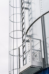 Industrial metal ladder with round railing