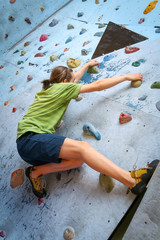 Obraz na płótnie Canvas Teenage Boy Training On Climbing Wall