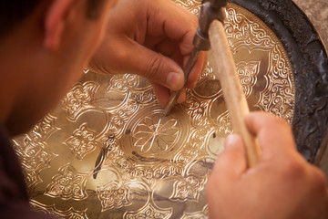 Artisans carving plates