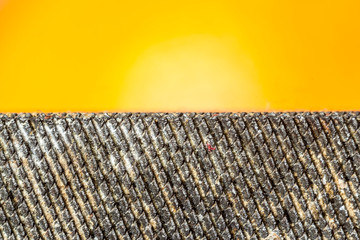 Metal tool rasp , close-up on an orange background. Mesh metal surface. Site about tools, metal,...