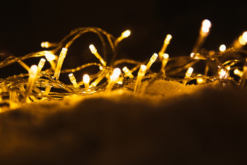 New Year's glowing garland on the snow