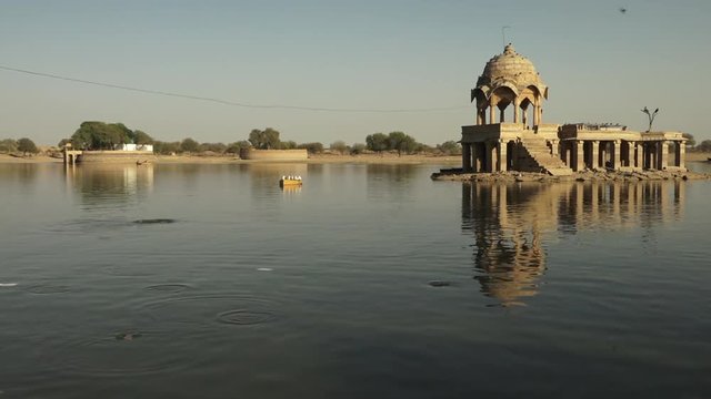 A close up shot of an old chhatris surrounded by waters 