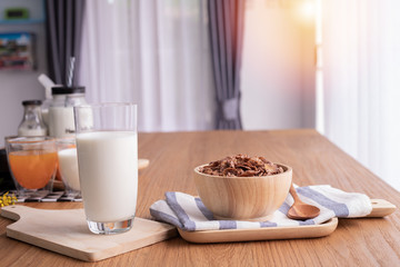 cereal breakfast with glass of milk on wood table in living room. top table.