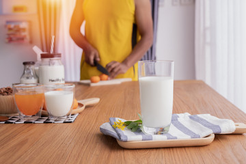 glass of milk with human preparing food for healthy and breakfast table. concept of health care lifestyle.