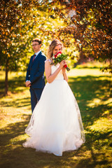 bride and groom on background summer forest