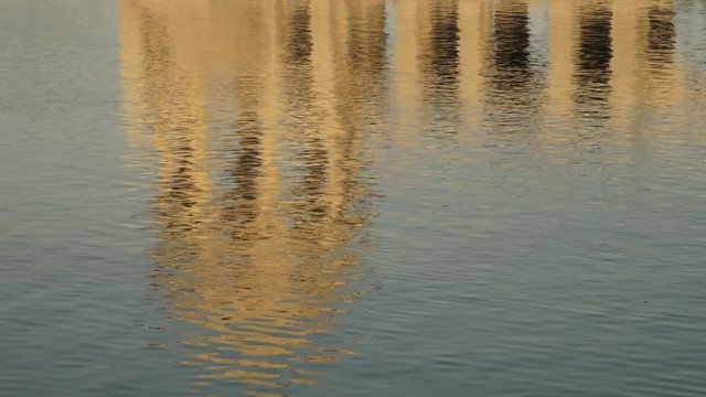 An extreme close up of a reflection of a cenotaph in a lake