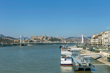 Fototapeta na wymiar view of tourist ships on the Danube on the background of the bridge and blue sky