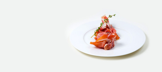  Parma Ham on a white plate on a white background isolated