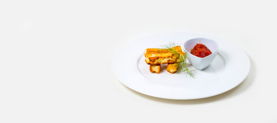 Fried halloumi and tomato dip on a white plate on a white background