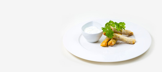 Spring Rolls and dip on a white plate on a white background isolated