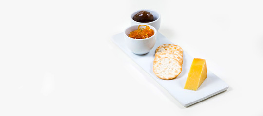Cheese and Crackers on a white plate on a white background isolated