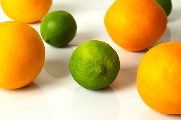oranges and lime on white background