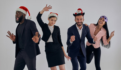 The four happy business people celebrating christmas