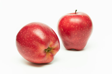 two red ripe apples on a white background close-up