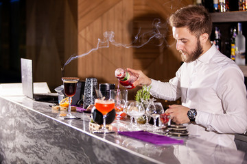 bartender pouring cocktail incredients. Lounge atmosphere