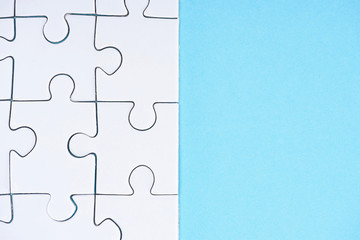 full frame of white puzzles arrangement on blue backdrop