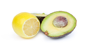 Brown avocado cut in half and partly cut lemon