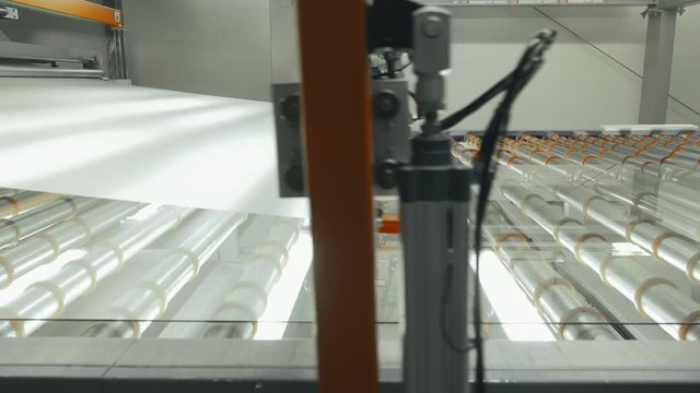 Professional equipment putting matte coating on surface glass in production hall