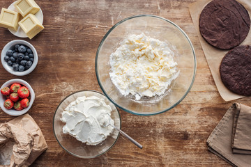 top view of ingredients for dough and cream on wooden table