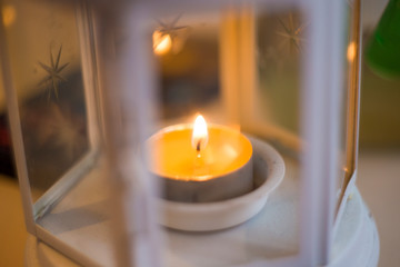 Accessories candlesticks with burning candles on white background. Blue tint composition for home, beauty salon and spa salon. Artistic retouching.